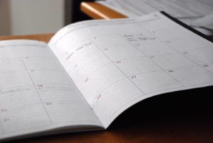 Monthly planning calendar laying open on a table