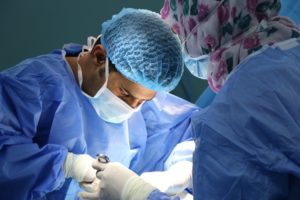 Two medical professionals working on a patient