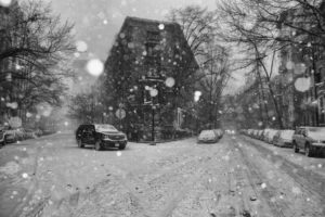 An empty neighborhood street during a snow blizzard