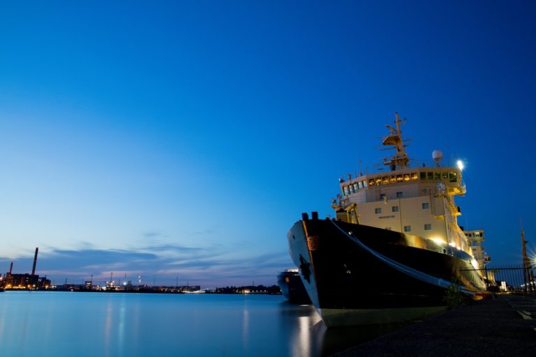 A docked boat with a few lights on