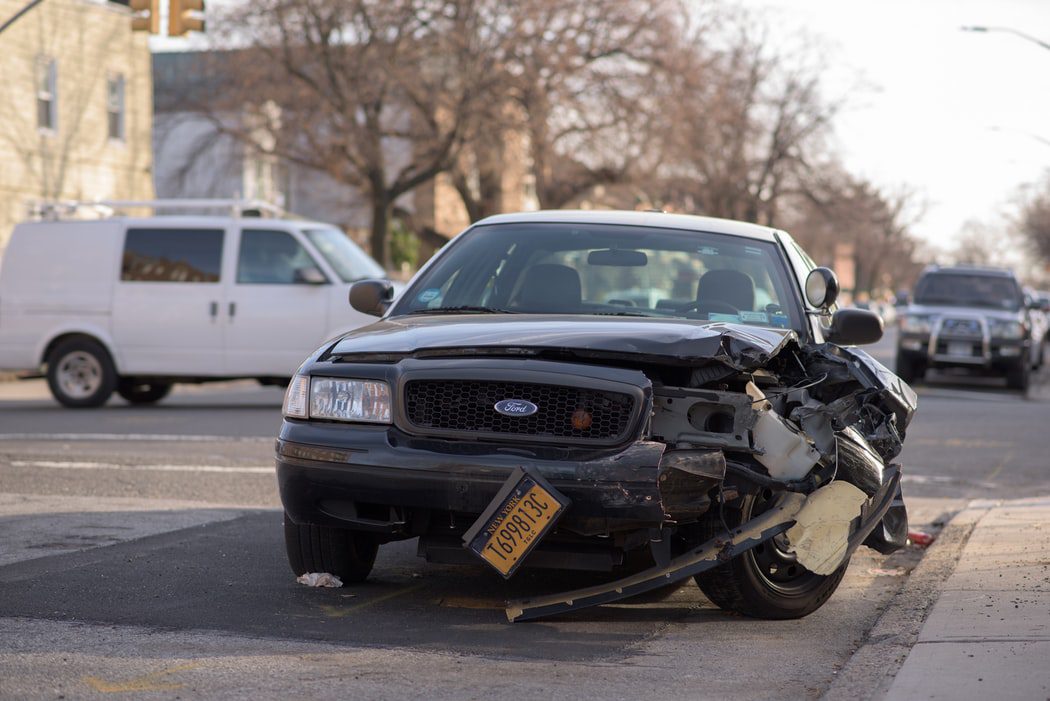 A damaged vehicle on the road after a car accident, representing the personal injury services of Leav & Steinberg LLP in New York, NY