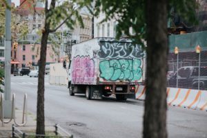 Grafitti'd truck parked on a street in New York City