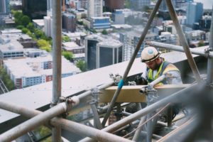 A construction worker holding a piece of wood