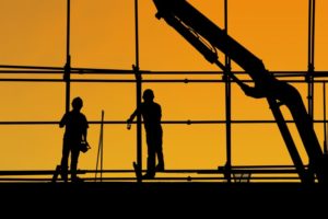 Two people on a construction site