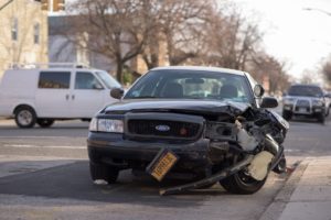 A wrecked vehicle in the middle of the street