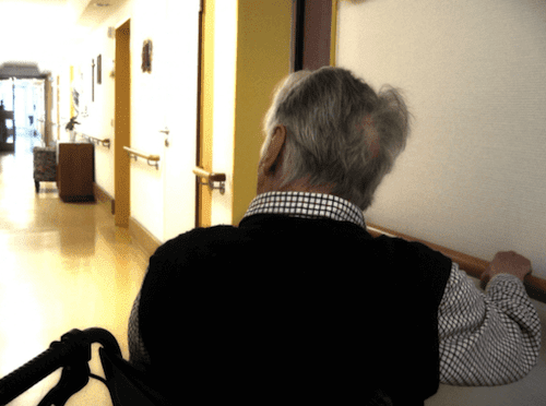 A man in the hallway of a retirement home