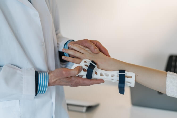 A medical professional examining a bone fracture