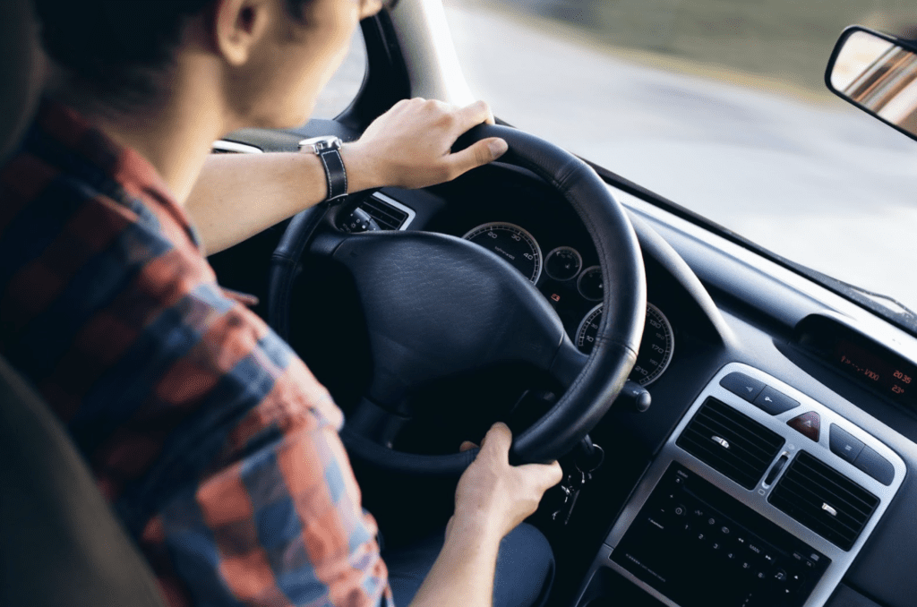 A young man driving a car