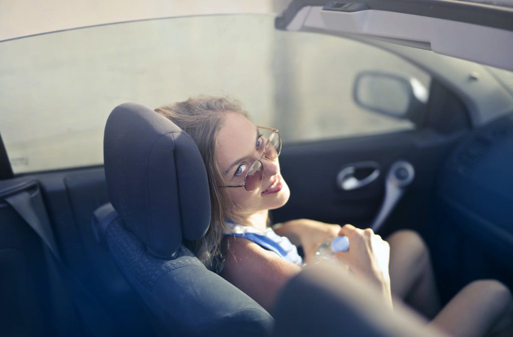 A woman sitting in a convertable