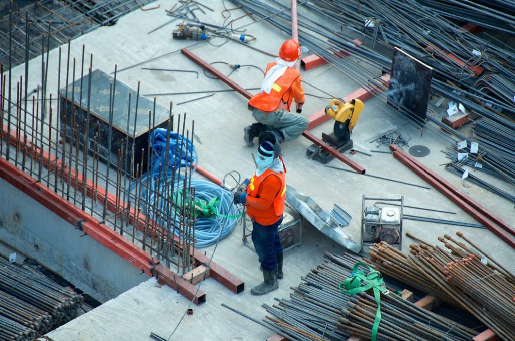 Two construction workers working at a construction site