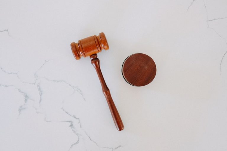 a gavel sitting on a white surface