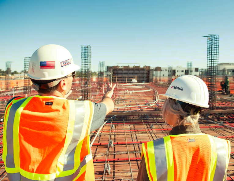 Construction workers observing a job site