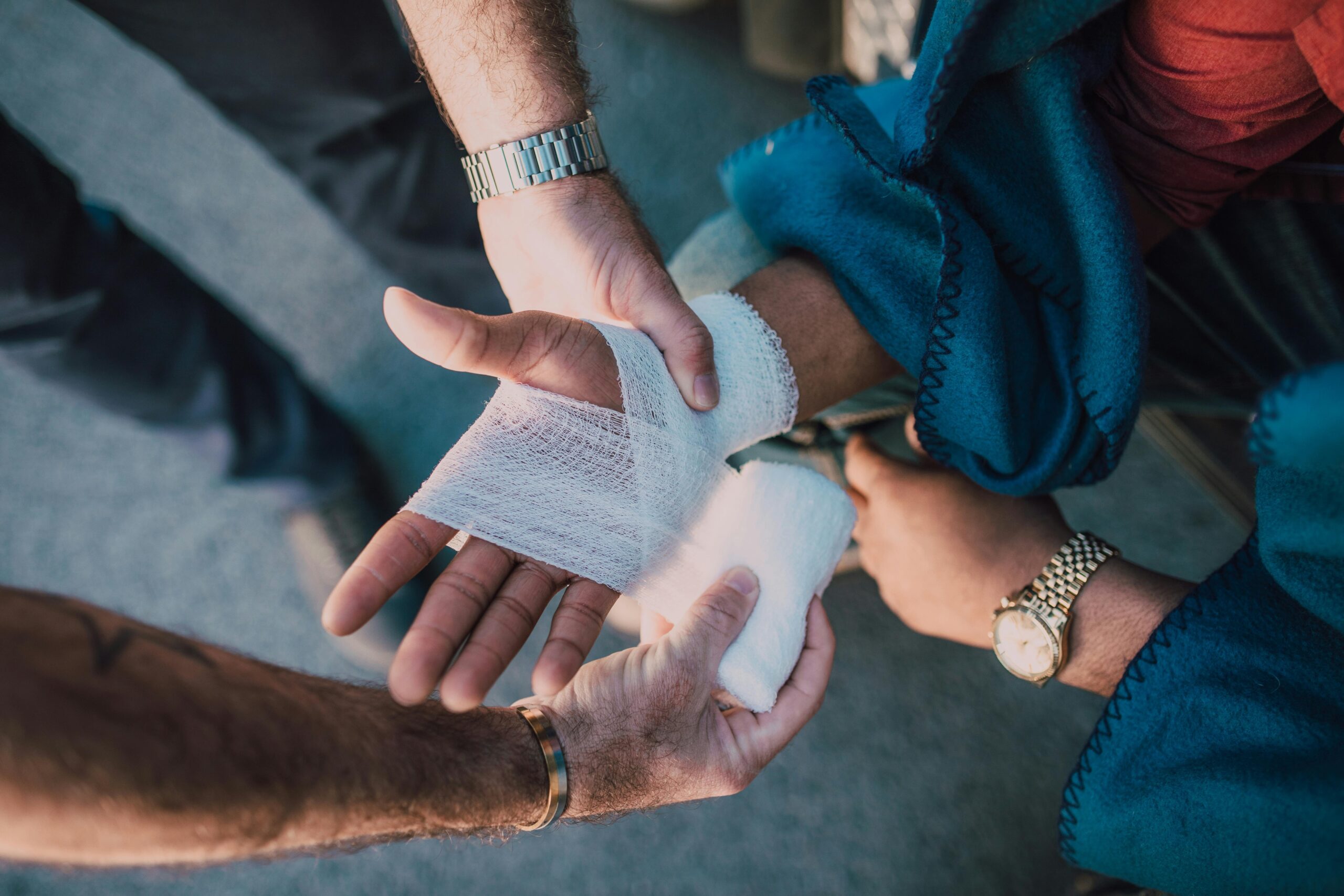 A person getting their hand wrapped in a bandage