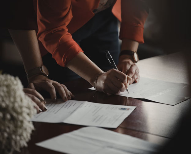People signing papers