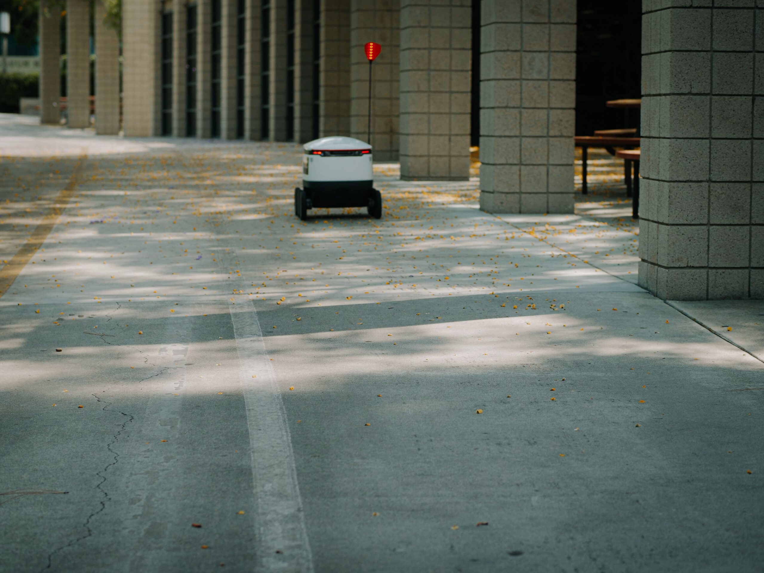 Futuristic autonomous robot on a delivery mission in a modern urban environment.